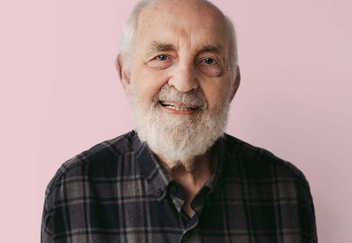Portrait of a smiling senior man with a white beard, representing geriatric eye care and patient satisfaction.