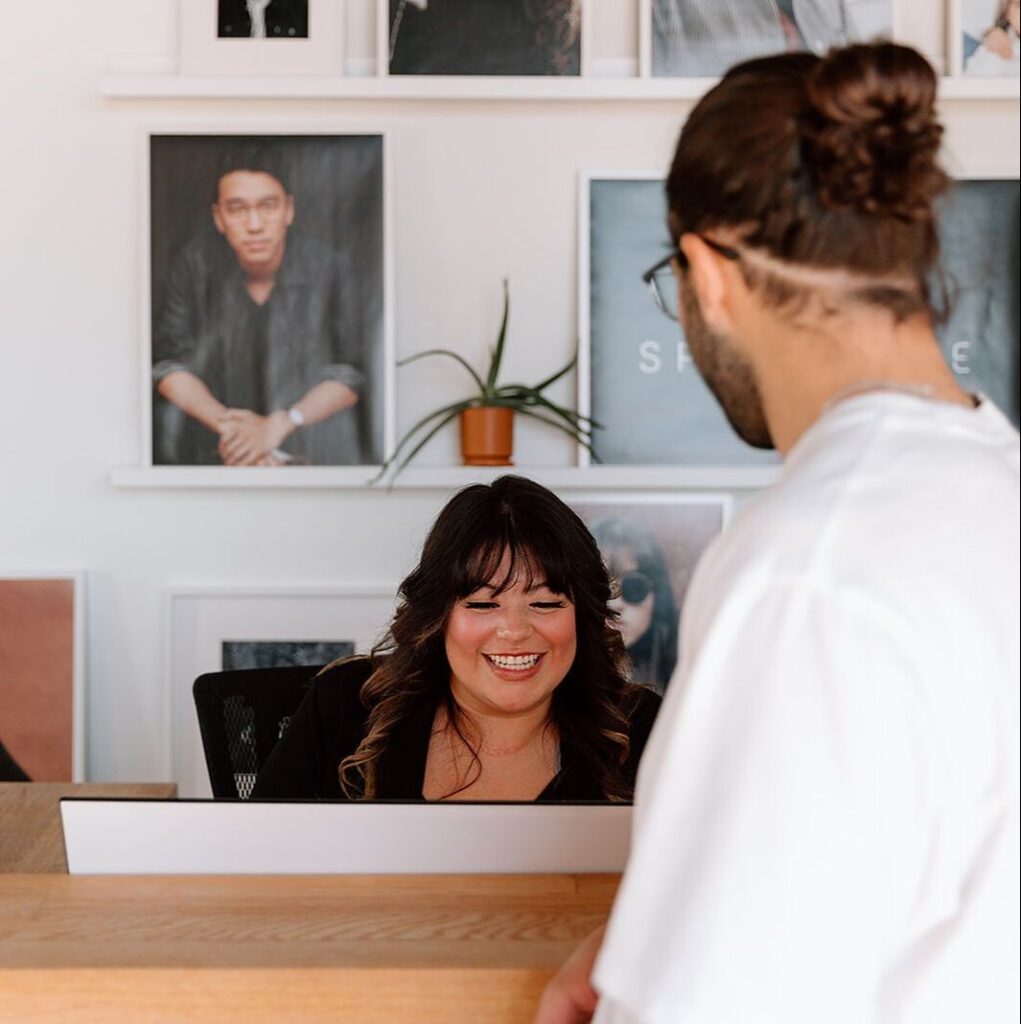 An optician showing a male patient different prescription lens options and tints during a personalized eyewear consultation.